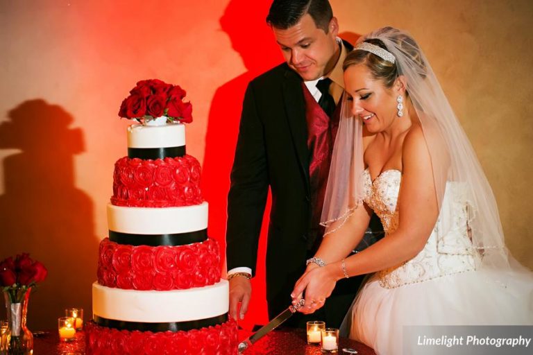 vivacious red and black mordern wedding cake cutting