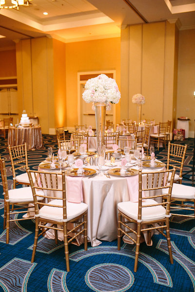 gold and blush wedding reception decor gold chiavari chairs A