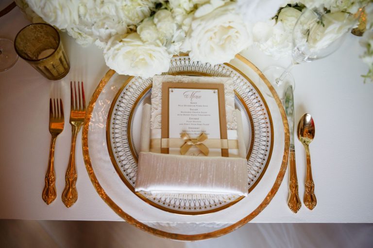 modern elegance styled shoot gold flatware - gold rimmed chargers