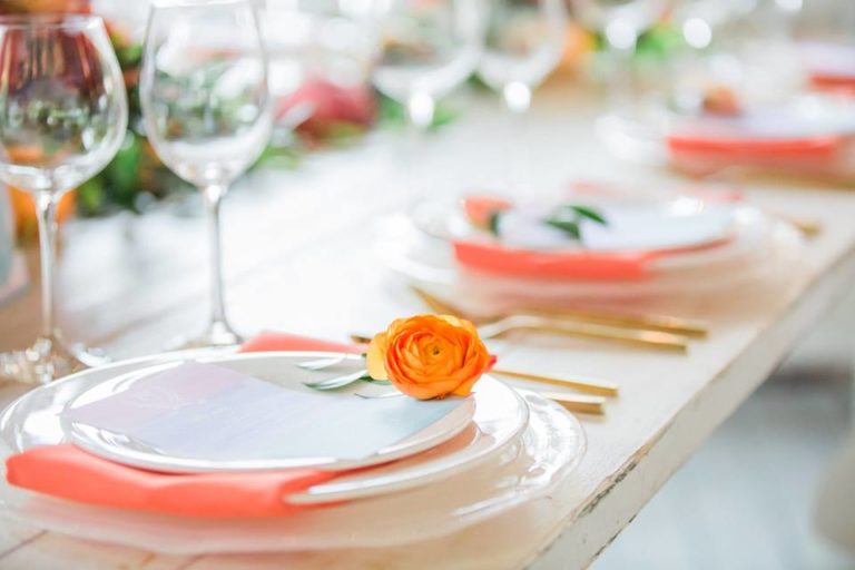 Paradise Cove wedding A Chair Affair farm table swirl charger coral napkin gold brushed flatware