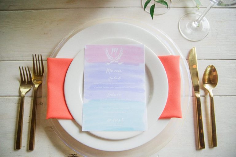 Paradise Cove wedding A Chair Affair gold brushed flatware coral napkins clear swirl charger