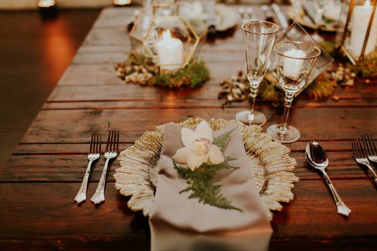 industrial wedding inspiration a chair affair farm table gold stemware gold seaburst charger 3