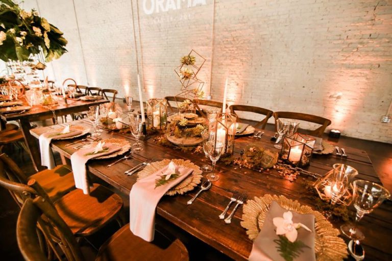 industrial wedding inspiration a chair affair farm table gold stemware gold seaburst charger 4