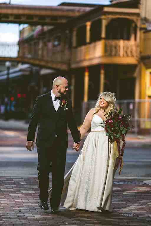 Romantic Cranberry and Gold Grand Bohemian Wedding A Chair Affair Couple Hand in Hand