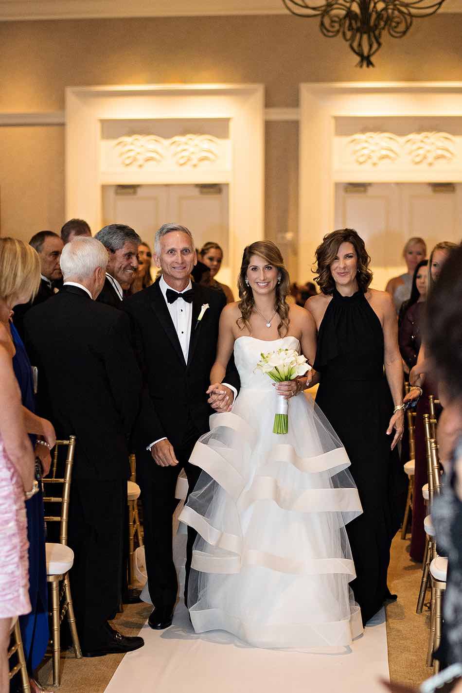 Jewish wedding A Chair Affair gold Chiavari chair walking down the aisle