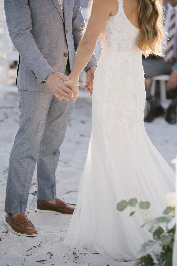 boho chic beach wedding A Chair Affair couple holding hands