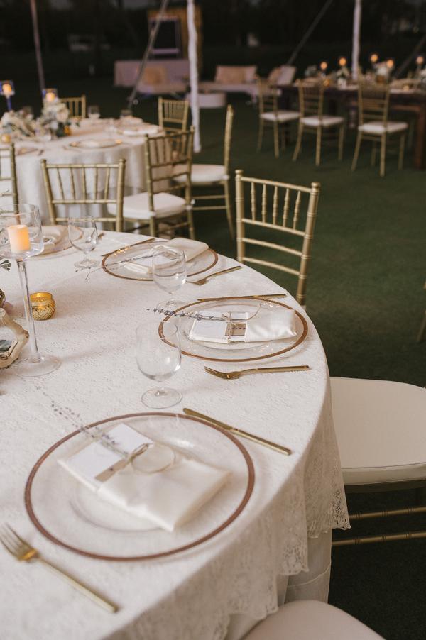 boho chic beach wedding A Chair Affair gold rim chargers and gold flatware