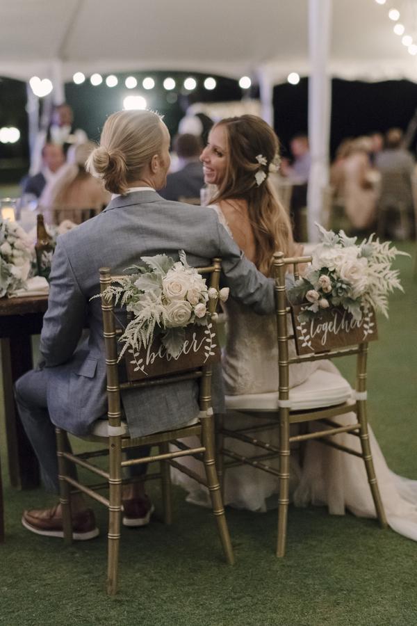 boho chic beach wedding couple at sweetheart table with gold chiavari chairs