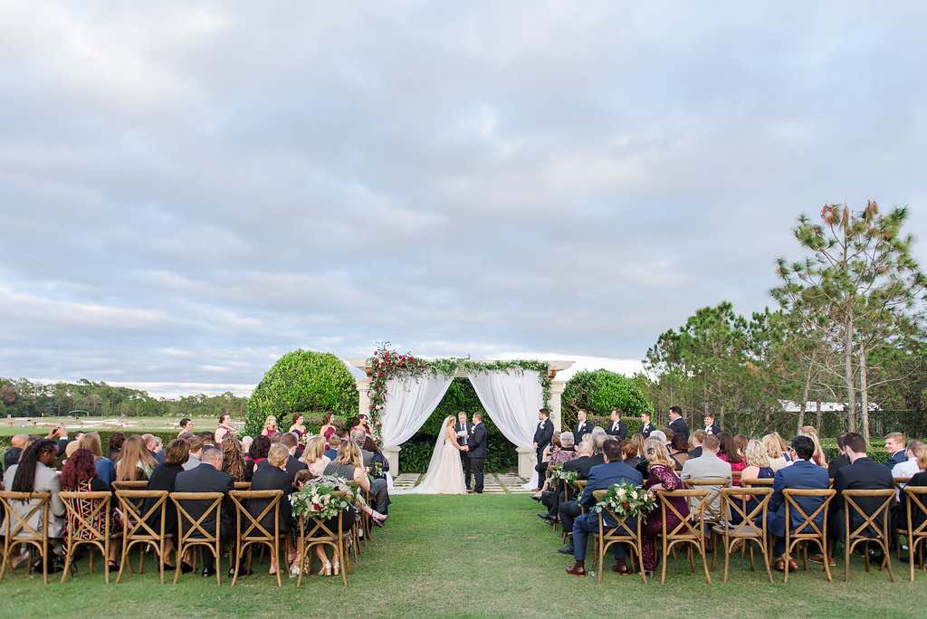 navy and burgundy wedding A Chair Affair French country chairs during ceremony