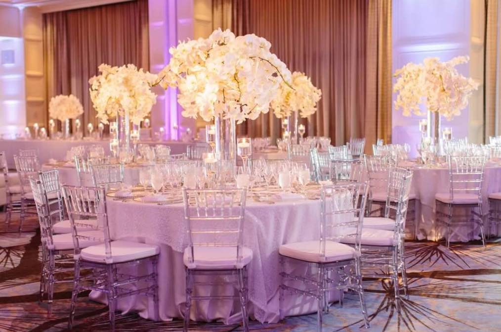 Floral Decor Reception Table with Clear Chiavari Chairs Greenery  Productions A Chair Affair - A Chair Affair, Inc.