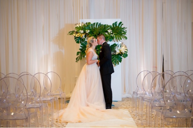 Modern Gold Ballroom Wedding Shoot A Chair Affair Couple with Ghost Chairs