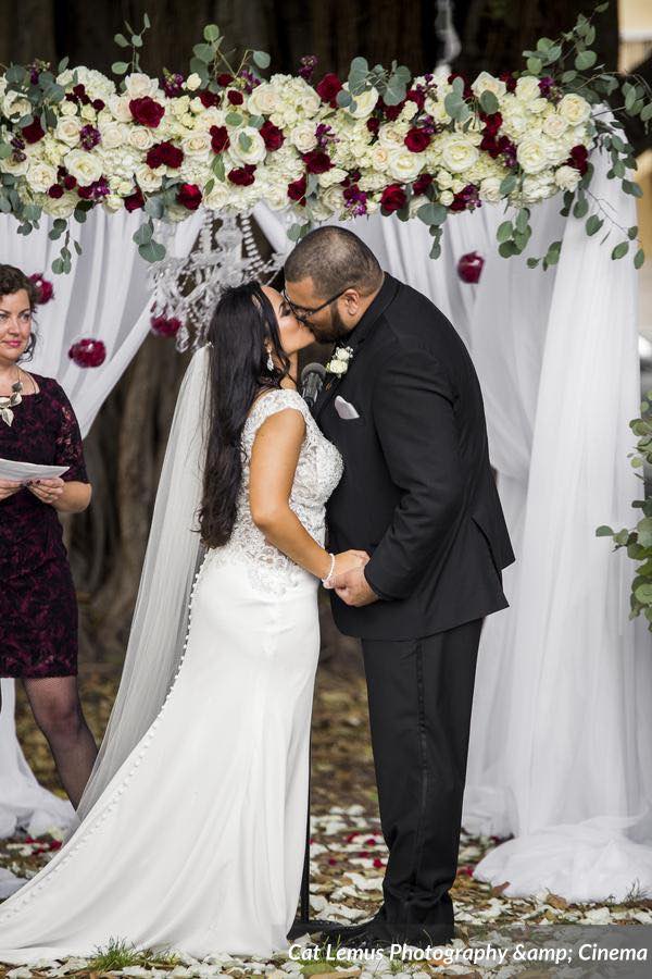 modern winter wedding A Chair Affair ceremony with floral arch