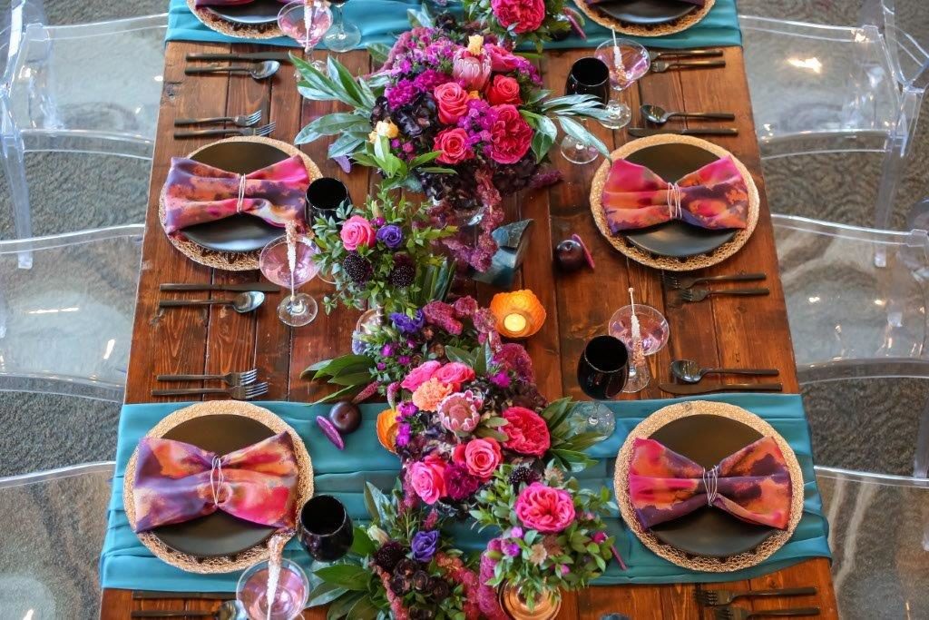 Isla del Sol Wedding Shoot-A Chair Affair-farm table-rose gold charger-black china-black goblets-black flatware