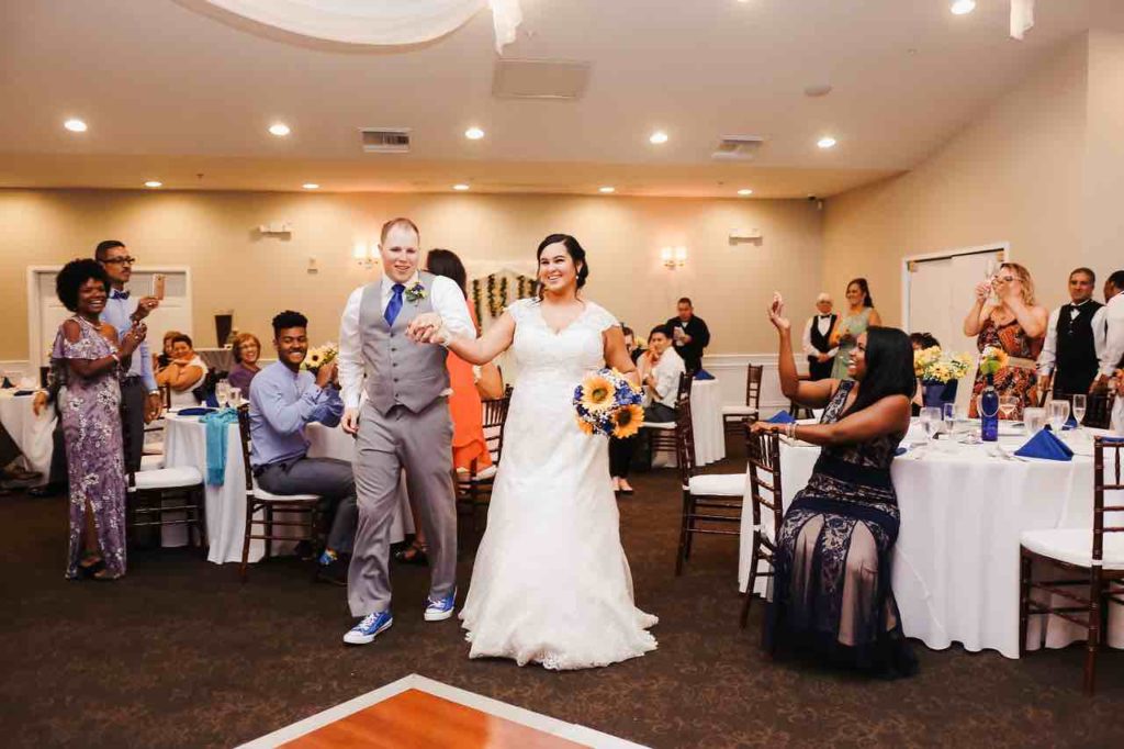 Royal Blue Wedding in Central Florida Couple Entrance A Chair Affair Mahogany Chiavari Chairs with White Pads It Takes 2 Photography