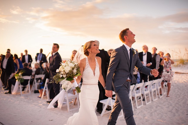 Carlouel Yacht Club Old Florida Wedding-Beach Ceremony Bride and Groom-White Folding Chairs-A Chair Affair