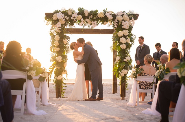 Carlouel Yacht Club Old Florida Wedding-Beach Wedding Kiss-White Folding Chairs-A Chair Affair