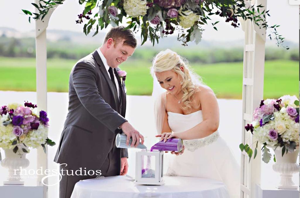 Purple and Silver wedding at Omni Resort A Chair Affair couple ceremony sand