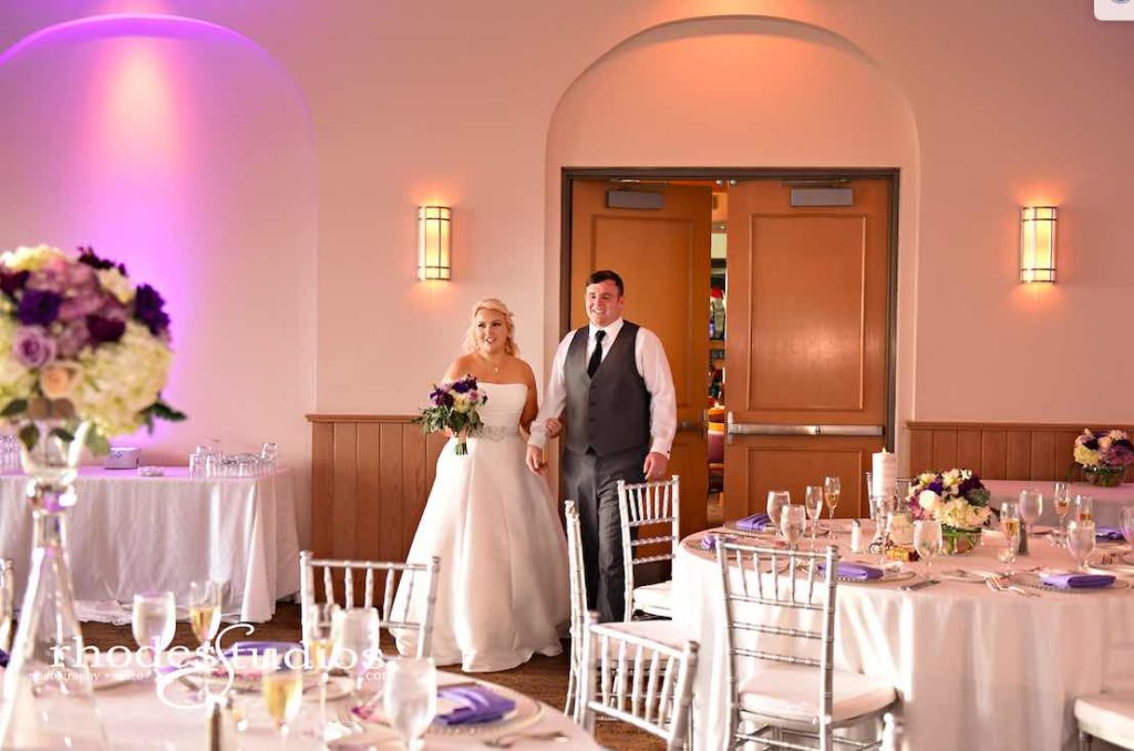 Purple and Silver wedding at Omni Resort A Chair Affair couple's first view of silver Chiavari chairs and silver belmont chargers at reception with amethyst napkins
