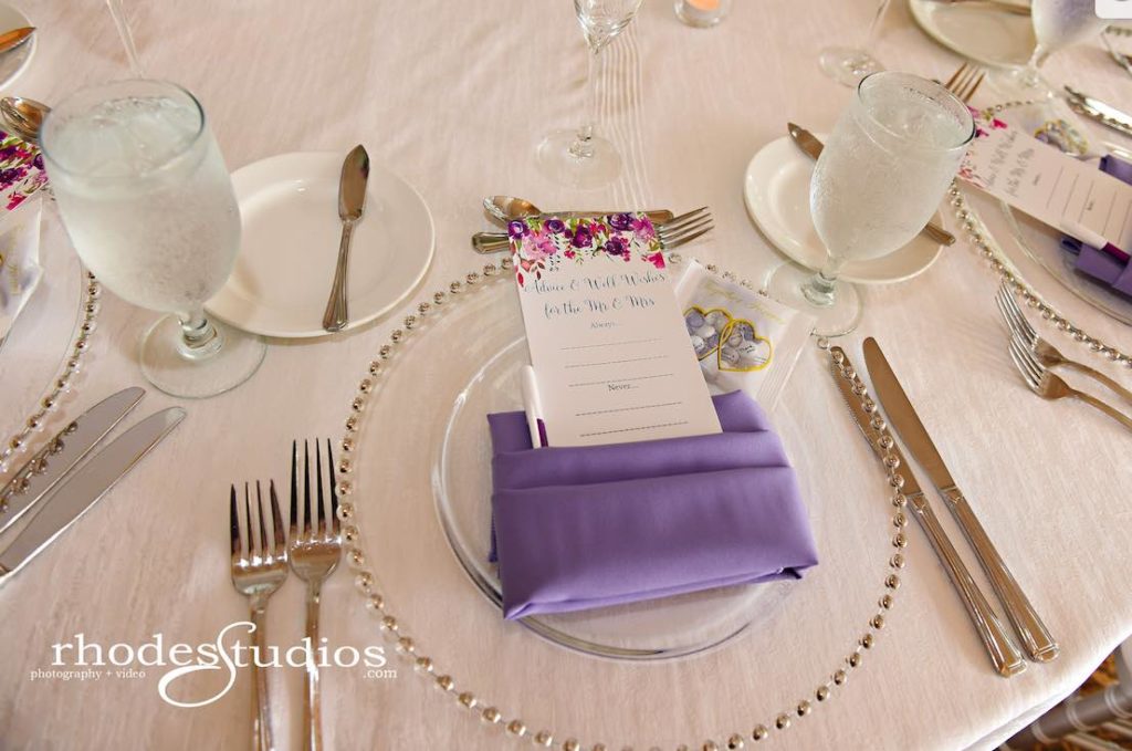 Purple and Silver wedding at Omni Resort A Chair Affair silver belmont chargers at reception with amethyst napkins