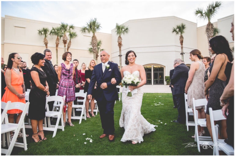 Cream and champagne Orlando wedding Omni Resort at Championsgate Brandon Kari Productions A Chair Affair white resin folding chairs at ceremony 