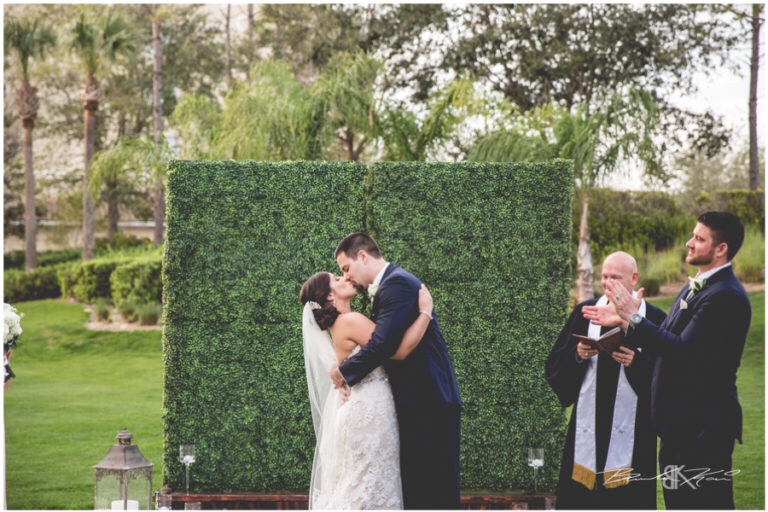 Cream and champagne Orlando wedding Omni Resort at Championsgate Brandon Kari Productions A Chair Affair hedgewood wall at ceremony 