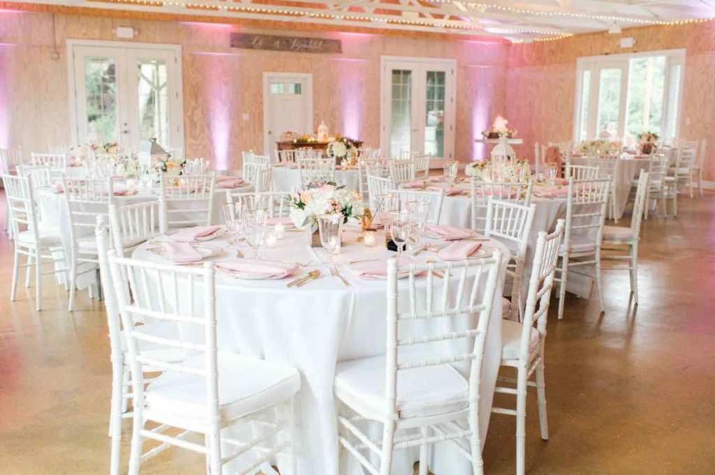 The Banyan Estate Blush and Ivory Wedding Flora Bloom Photography A Chair Affair white Chiavari chairs with white pads and gold rimmed stemware