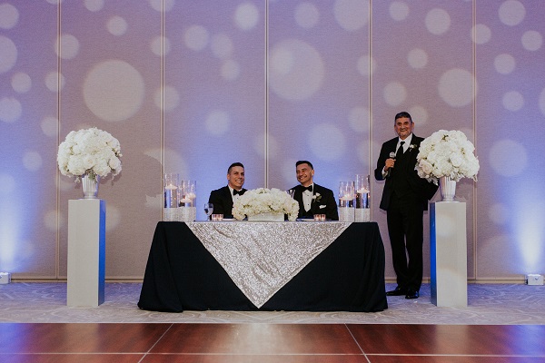 Alfond-Inn-Wedding-A-Chair-Affair-LGBT-Wedding-Silver-Glitter-Rim-Sprial-Chargers-Navy-Linens-Sweetheart-table