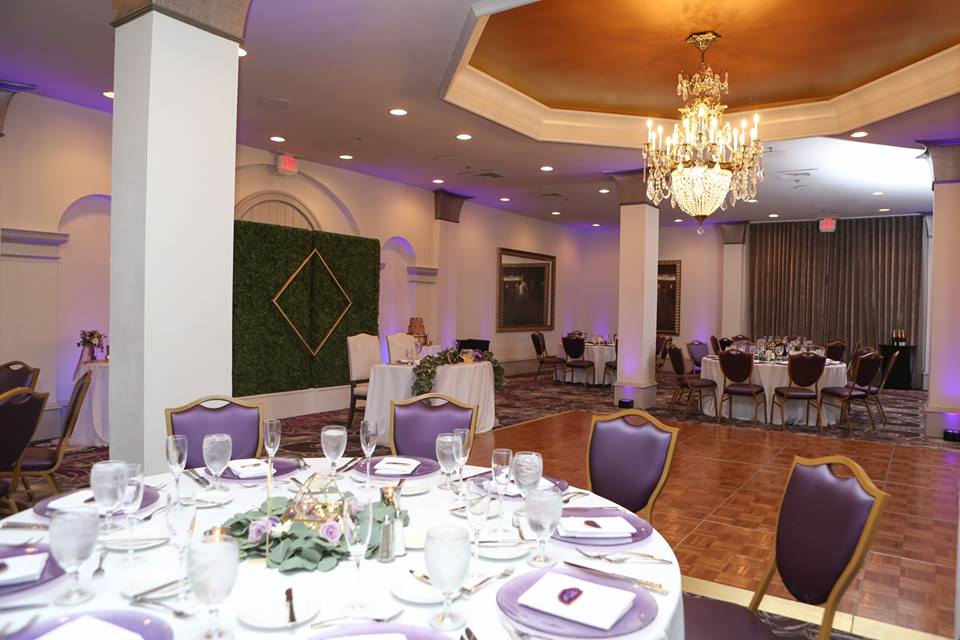 castle hotel wedding chair affair purple glitz glass chargers hedge wall white base