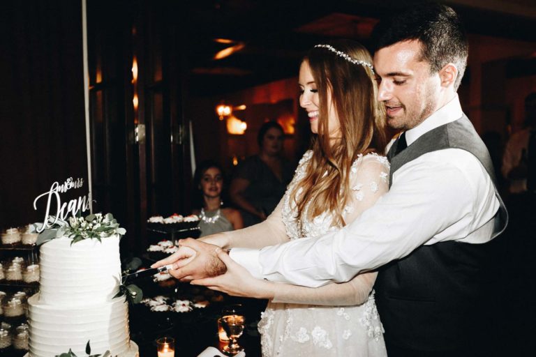 Cutting the Ivory and Green Wedding Cake