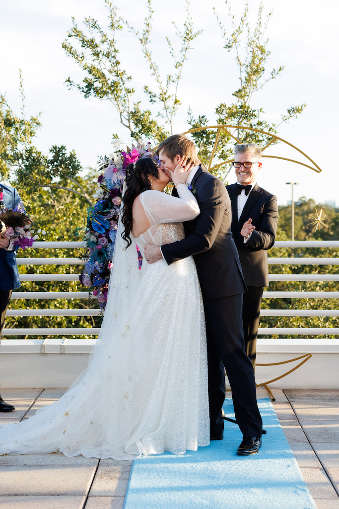 bride and groom first kiss whimsical ceremony