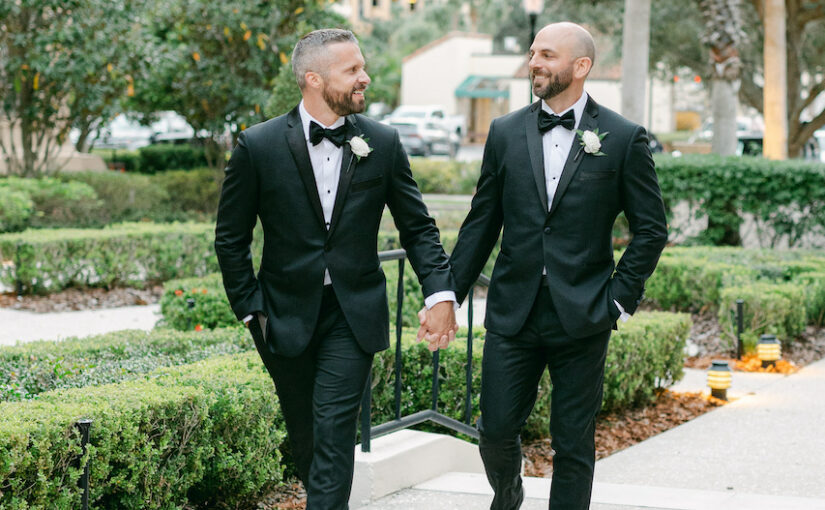 Nick & Robbie holding hands at the Alfond Inn.