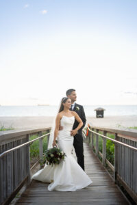 The couple poses on the boardwalk at the Marriot Harbor Beach Resort