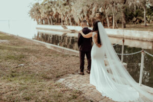 A bride sneaks up behind the groom for a quick first look before their ceremony at the Powel Crosley Estate.