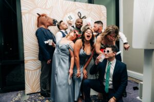 Fairytale Wedding at The Hyatt Regency Grand Cypress reception the friends are using the photo booth and props to take pictures