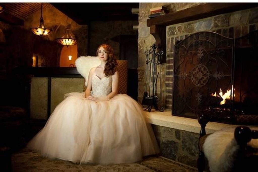 Bride pictured by fireplace at The Bella Collina venue