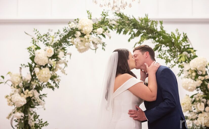 Bride and groom sharing first kiss during ceremony. New Smyrna wedding rentals