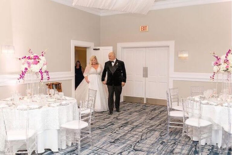 Bride and groom entering the reception ballroom at The Rusty Pelican.