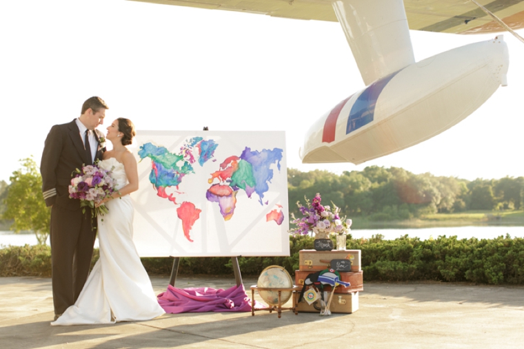 Travel inspired wedding shoot. Bride and groom portrait next to plane and decor