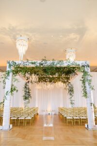 The wedding ceremony at The Haya Hotel including Tampa Wedding Rentals. A Chair Affair provided Gold Napoleon Chairs and White Pads.