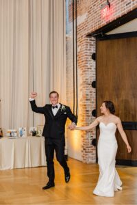 The bride and groom entering the reception