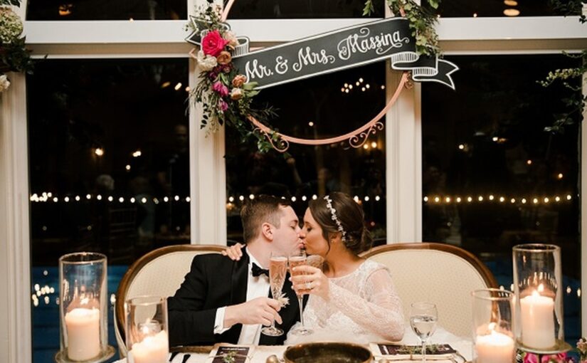 Bride and groom sharing a kiss while they toast at their Winter Park Racquet Club Wedding.