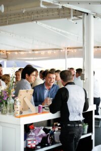 Guests enjoying drinks from A Chair Affairs White Cosmo Bar during cocktail hour