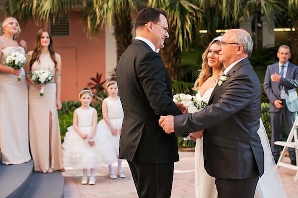 The bride being escorted down the aisle by her father and then he hands her off to her future husband at the end of the aisle