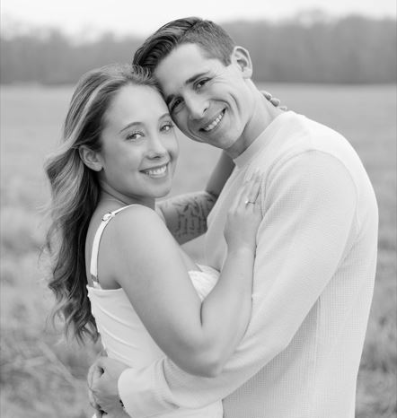 January Monthly Wedding winners in a black and white photo embracing in a hug for the picture