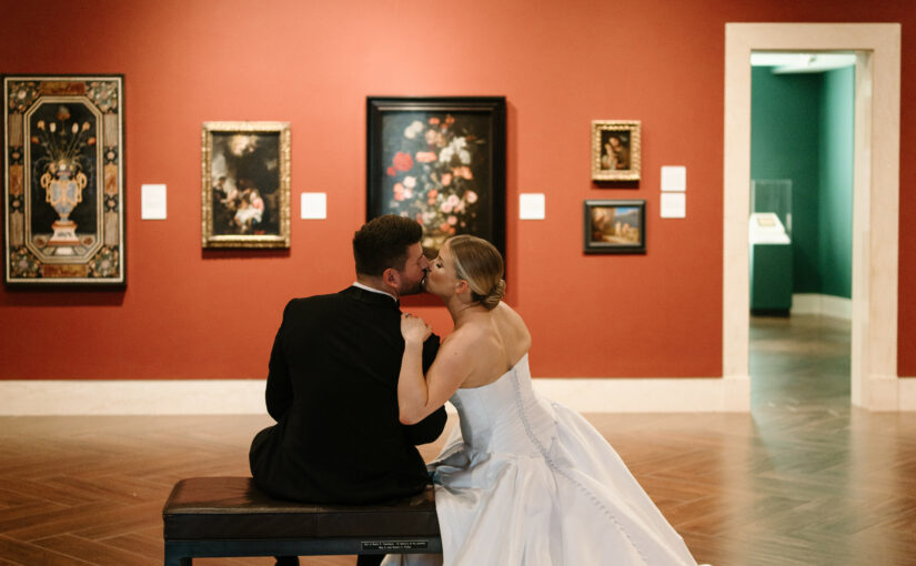 Bride and Groom kissing at The Museum of Fine Arts in St Petersburg Florida with Wedding Event Rentals provided by A Chair Affair.