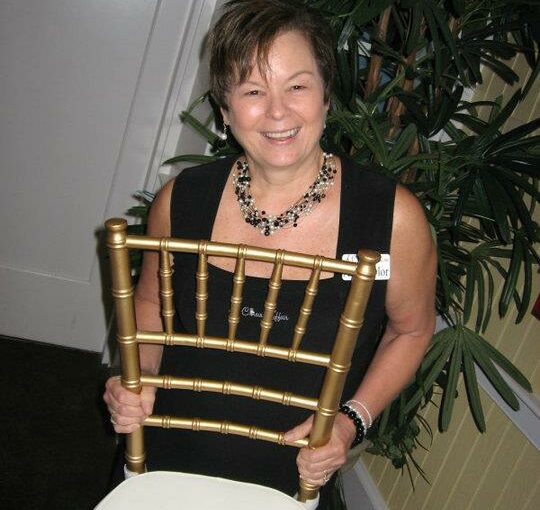 Ann-holding-a-gold-chiavari-chair-from-A-Chair-Affair. Orlando Wedding Rentals. From a Box Truck Dream to Bustling Warehouses: The Early Growth of A Chair Affair
