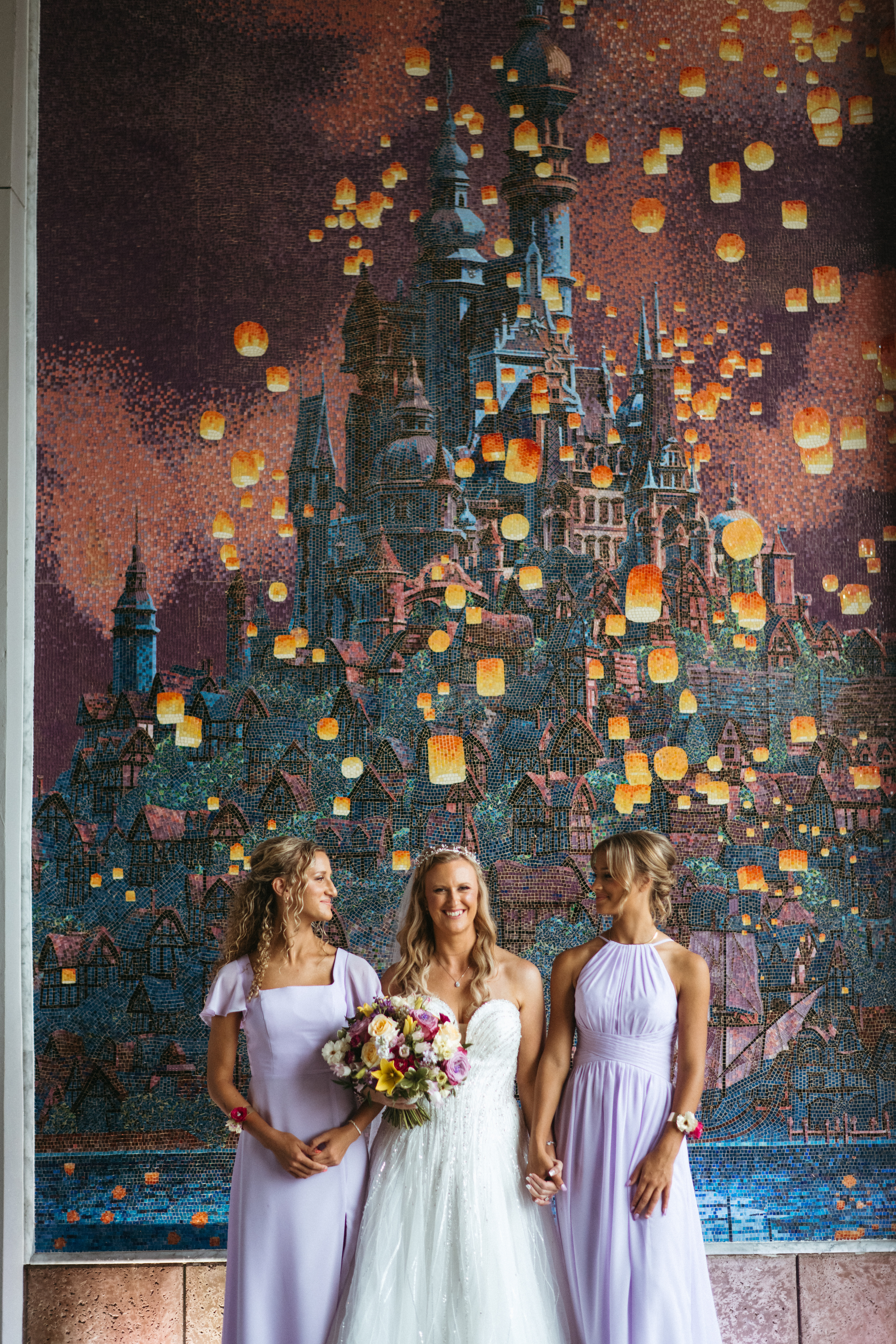 Bride-and-bridesmaids-in-front-of-portrait-of-the-lights-from-Rapunzel-