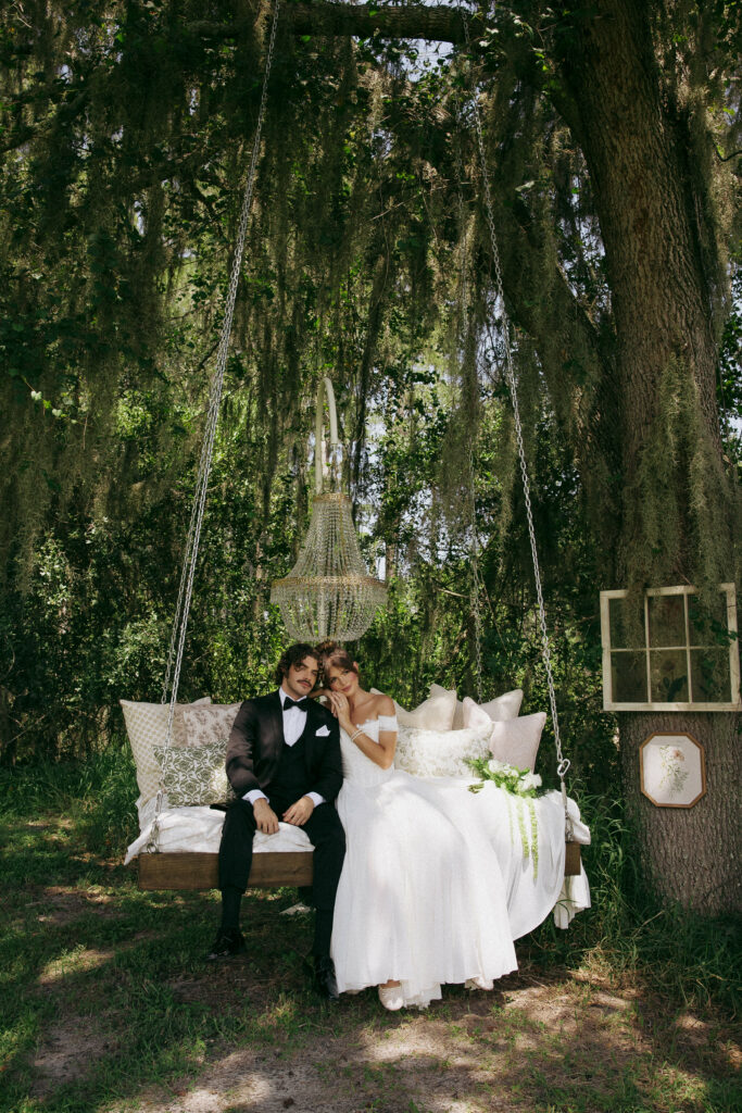 Bride and Groom on wooden swing at Nuptials in Nature. Orlando Wedding Rentals. Central Florida Wedding Rentals