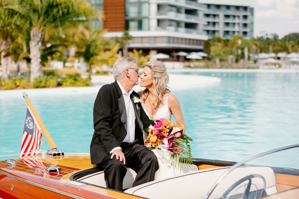 Morgan and Bryan kissing on the boat at Evermore Resort. Orlando Wedding Rentals. Central Florida Wedding Rentals. Chiavari Chairs. Chargers