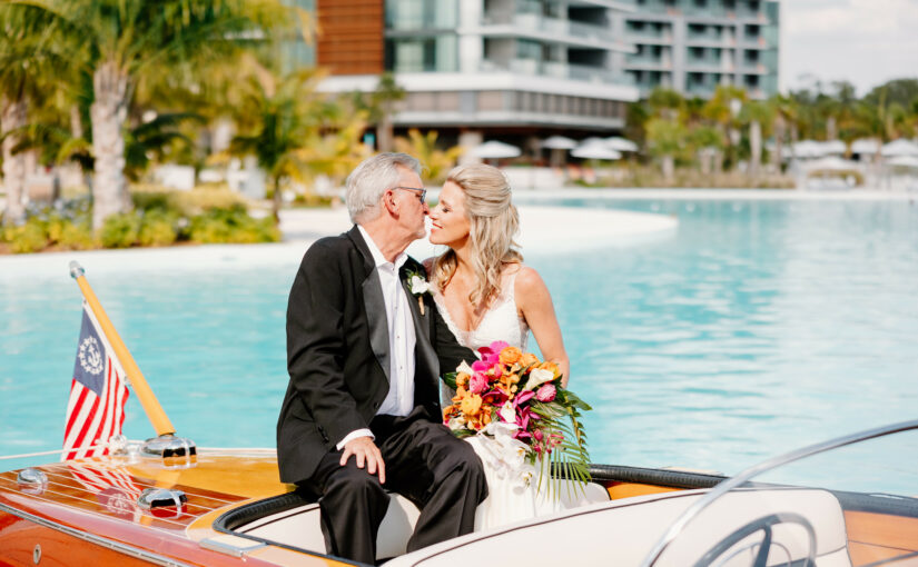 Morgan and Bryan kissing on the boat at Evermore Resort. Orlando Wedding Rentals. Central Florida Wedding Rentals. Chiavari Chairs. Chargers